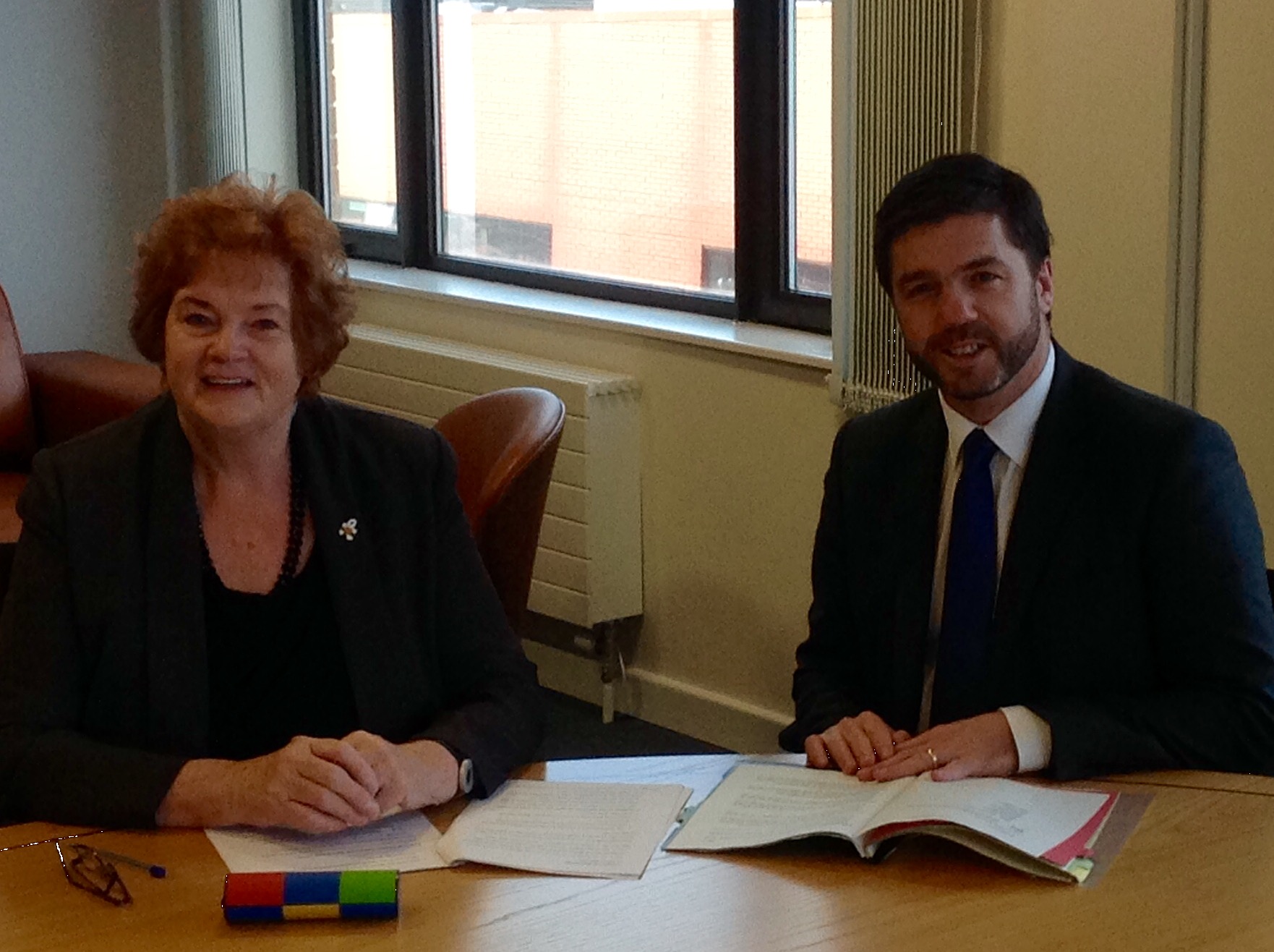 Presiding Officer Rosemary Butler sitting at a table with Stephen Crabb, Secretary of State