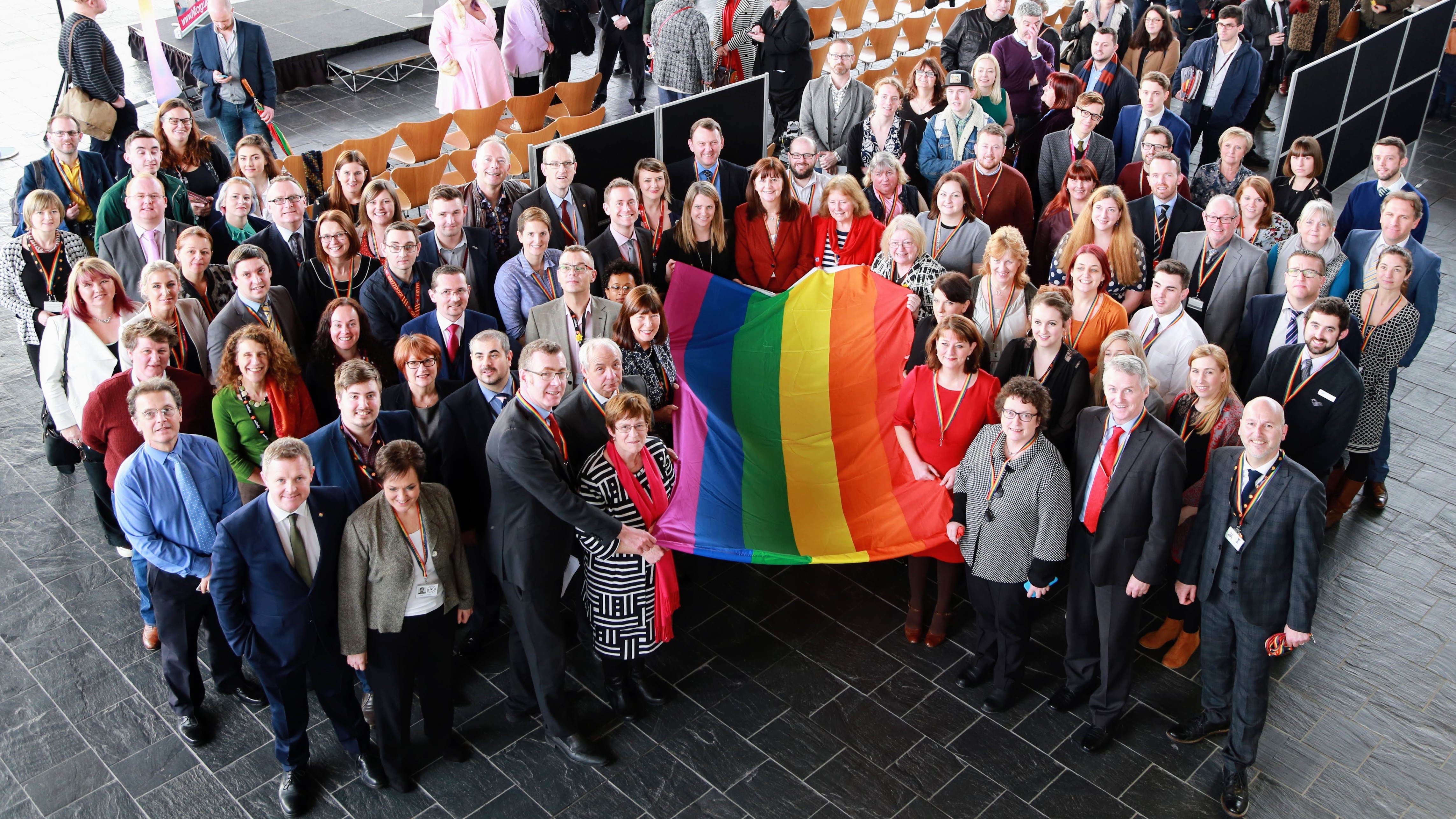 photo - LGBT staff and allies with the rainbow flag