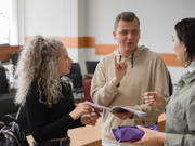 Image of three young people signing to each other