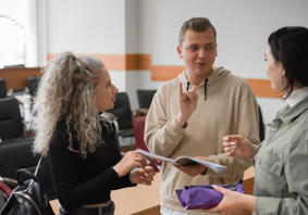 Image of three young people signing to each other