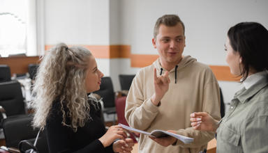 Image of three young people signing to each other